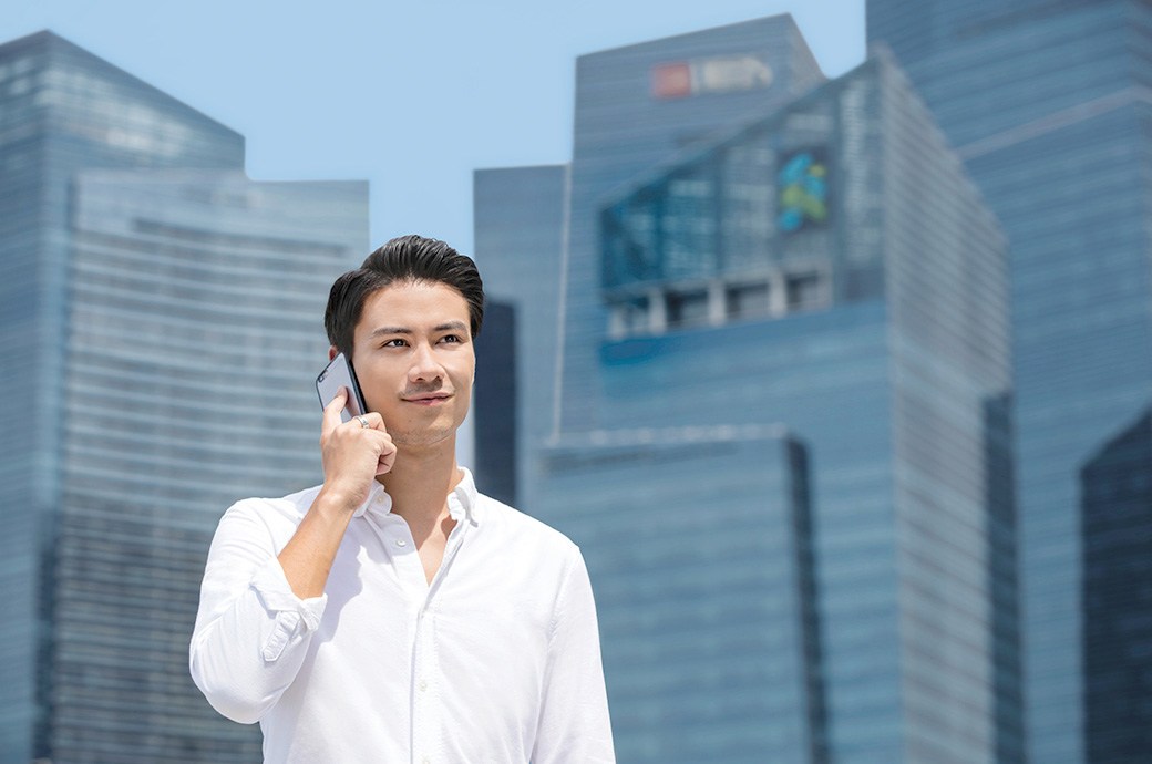 Working adult on handphone, ACUVUE® contact lenses, Malaysia