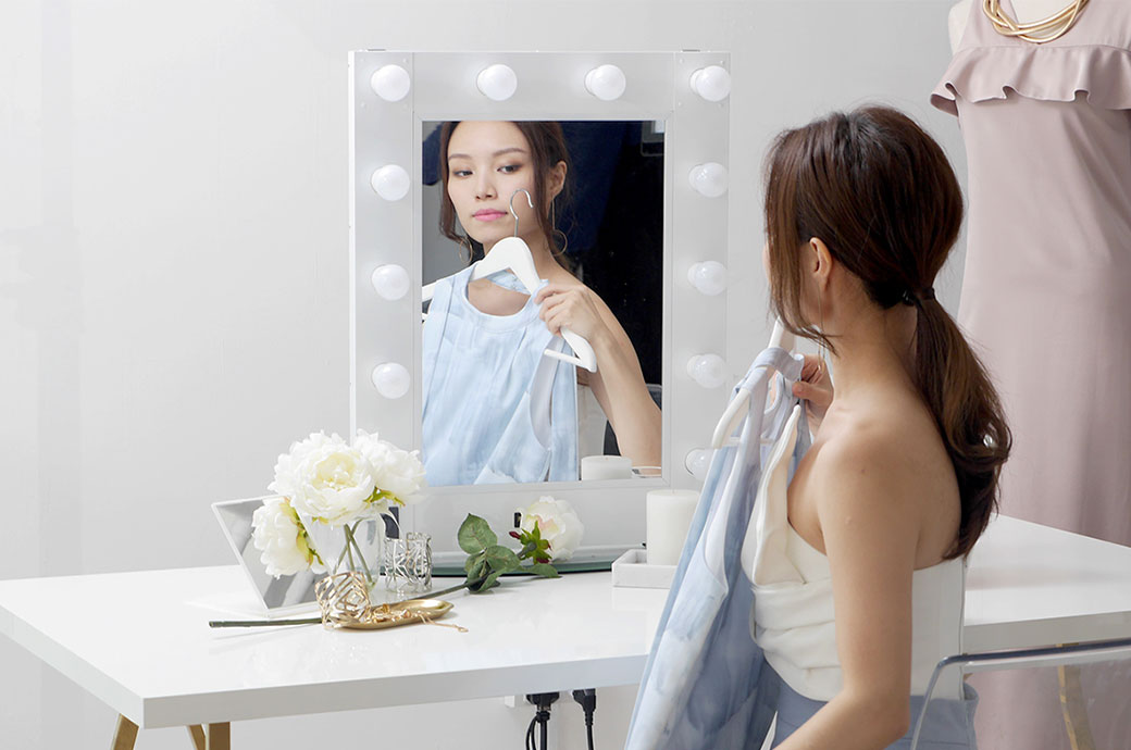 Woman trying on a dress in front of mirror, ACUVUE® DEFINE® contact lenses, Malaysia 